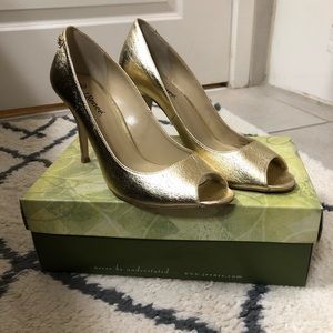 Woman’s gold peep toe heels